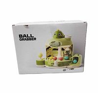 Front of box showing green dinosaur Yabao Ball Grabber claw machine