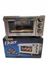 Front view of Oster countertop oven sitting on retail box