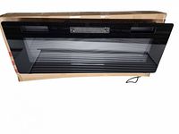 Front view of electric fireplace showing glass panel and power cord