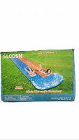 Retail box showing Sloosh Waves Double Lawn Water Slide and users