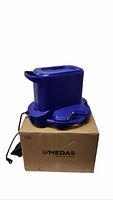 Blue Medas submersible pump on top of original box, side view showing handle and cord