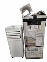 Portable AC unit next to original box with exhaust hose attached to box