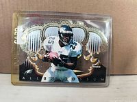 Front view of Allen Rossum die-cut rookie card in protective sleeve
