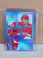 Front of Upper Deck UD Canvas Alex DeBrincat hockey card in top loader