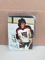 Front of Don Murdoch hockey card in sleeve