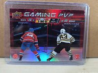 Front view of holographic Gaming PVP card showing Suzuki and Marchand in play stance