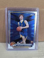 Front of Topps Chrome Brandin Podziemski blue foil rookie card in top loader