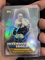 Front view of Topps International Idols Peter Bondra holographic card in top loader