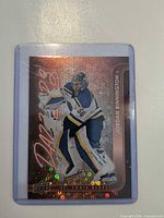 Front of Jordan Binnington Dazzlers holographic trading card in sleeve