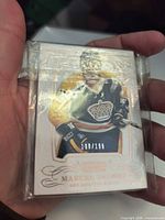 Front of sleeved Marcel Dionne National Treasures card showing serial number 198/199