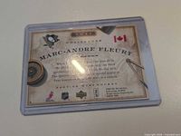 Back of Marc-Andre Fleury Upper Deck MVP card showing bio, logos, condition