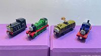All four die-cast trains lined up side by side
