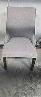 Front view of light grey upholstered accent chair