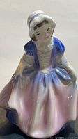 Front view of Royal Doulton Dinky Do figurine showing dress colors and facial detail