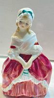 Front view of Royal Doulton Peggy figurine showing dress, shawl and facial features