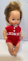 Front view of 1976 Barbie Heart Collection child doll in red romper