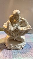 Front view of ivory Holy Family sculpture on base
