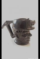 Side view showing sculpted coal miner head and pickaxe handle