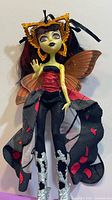 Front view of Luna Mothews doll showing outfit, wings, boots, headpiece