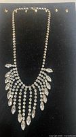 Full view of rhinestone bib necklace on display board