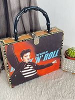 Front view showing Elvis graphic, handle, latch