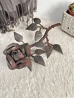 Full view of metal rose on faux fur surface