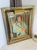 Full view of brass frame with Elvis portrait