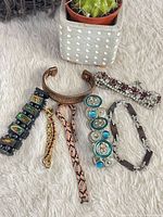 Group shot of seven assorted bracelets on faux fur backdrop