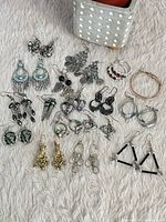 Overview of all earrings and bangles laid out on surface