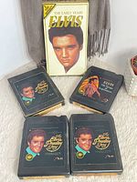 Group photo showing VHS and four 8-track tapes