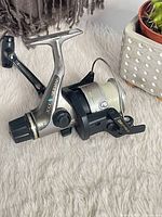 Left side view of Shimano 2000 Sidestab reel showing spool, handle, drag knob