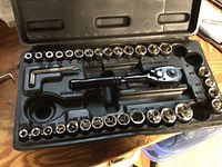 Open socket set showing sockets, ratchet, handles and extensions in organizer tray