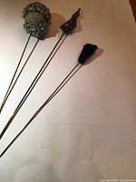 Three hatpins showing snail shell cluster, filigree diamond, black micro-beaded form