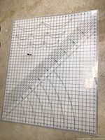 Flat view of large gridded cutting board with measurement rulers and alignment lines