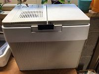 Front and side view of Koolatron thermoelectric cooler showing body and lid
