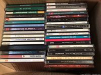 Box containing two vertical stacks of jewel-case music CDs