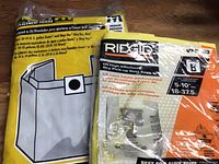 Packaged Ridgid dust bags beside Genie/Shop-Vac filter bag