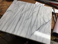 Top view of white marble pastry board with grey veining