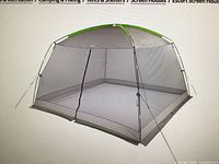 Stock image of assembled grey mesh screen house with green trim