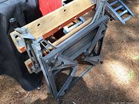 Folding Workmate shown collapsed, steel frame and wooden jaws visible