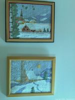 Both framed hooked wool artworks displayed on wall