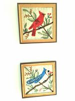 Both framed hooked bird artworks shown together