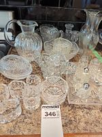 Group shot of all crystal and pressed glass pieces on countertop