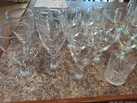 Group of stemmed goblets and one tumbler on countertop