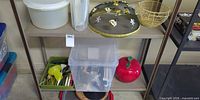 Shelf view showing most items including storage containers, mesh dome cover, wire basket, clear tote, apple canister and utensil tray