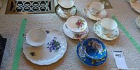 Group shot of all five teacup sets showing cups, saucers and plates