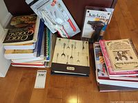 Overview of cookbooks, binders and two packaged kitchen tools