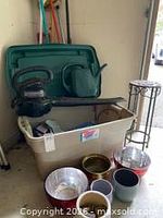 overview of tote, leaf blower, watering can, plant pots, plant stand, long-handled tools