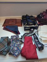 Overview of ties, suspenders, pocket squares, scarves, gloves, tray