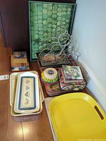 Overview of lot showing trays, wine rack, framed art, placemats, napkins and holder